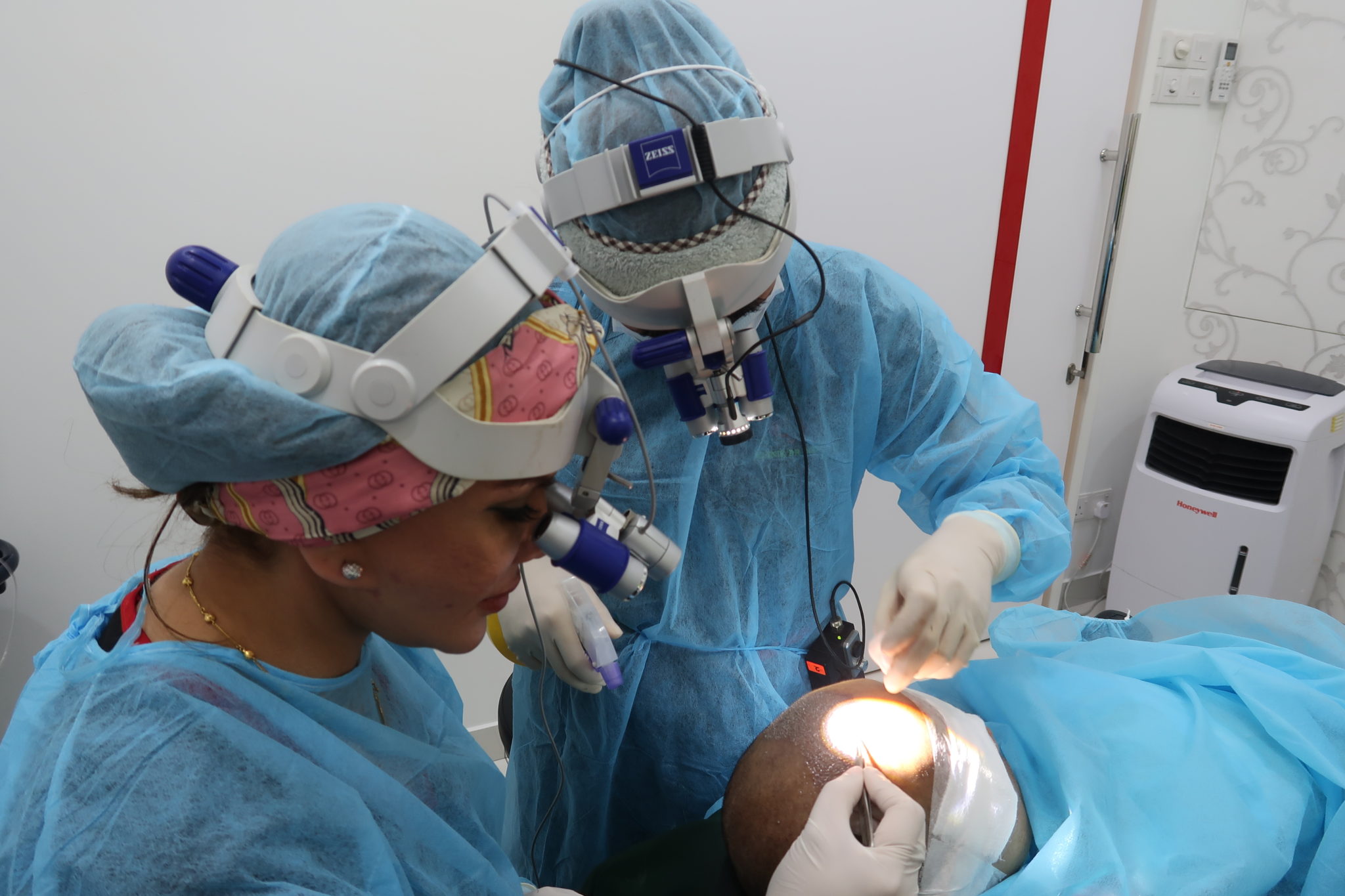 Dr Inder And Assistant Planting The Hair Grafts